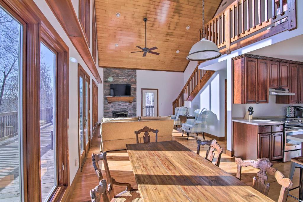 a dining room with a large wooden table and chairs at Secluded Hilltop Columbia Home with Deck and Views! in Columbia