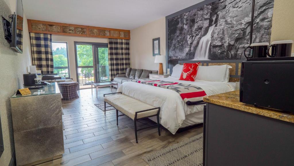 a bedroom with a bed and a living room at Chetola Resort at Blowing Rock (Lodge) in Blowing Rock