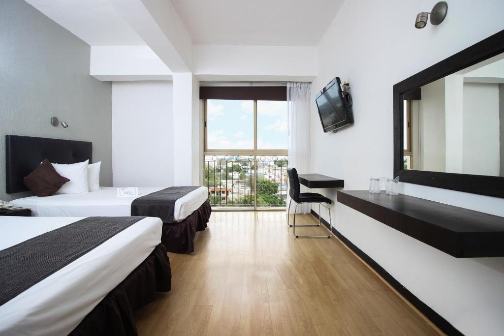Postel nebo postele na pokoji v ubytování Hotel Maya Yucatan