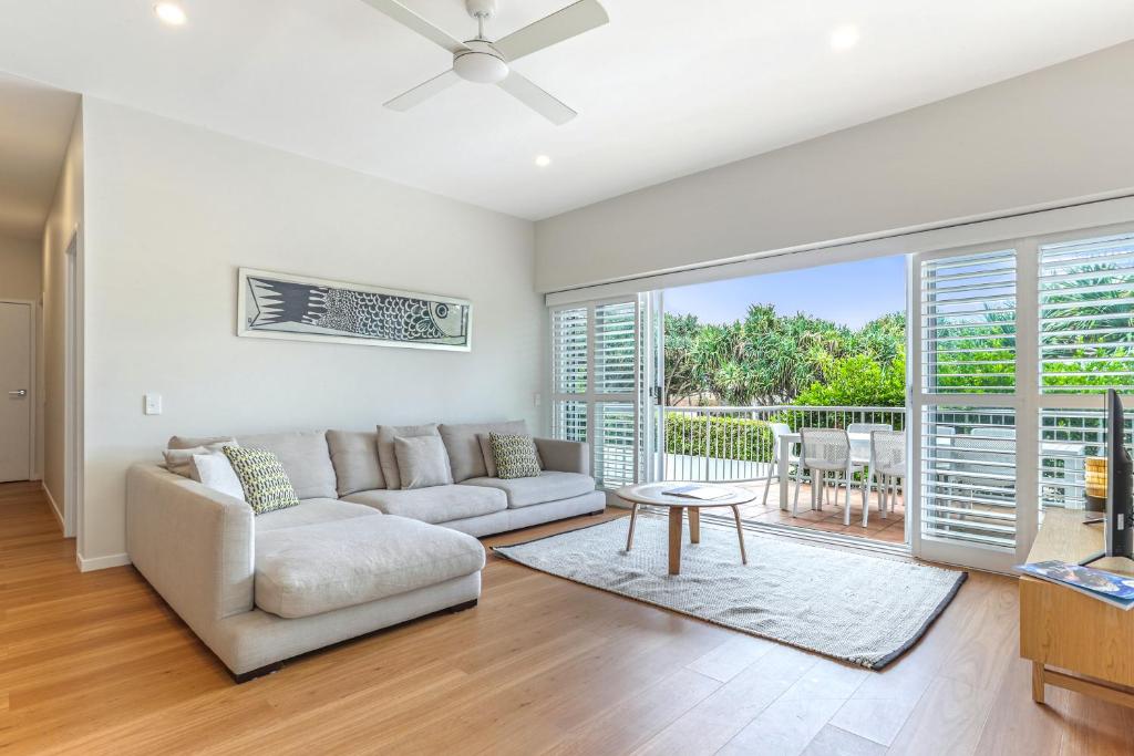 a living room with a couch and a table at Location, location, Sunshine Beach in Sunshine Beach