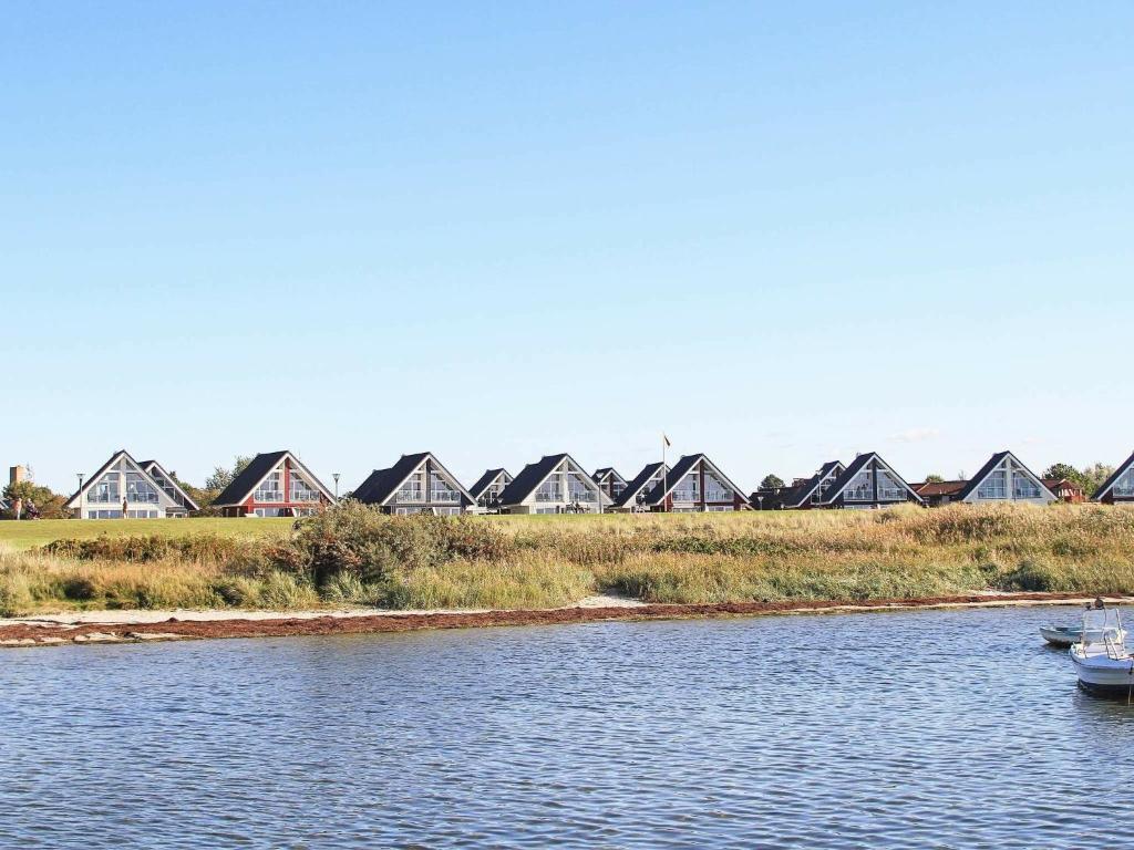 a row of houses on the shore of a river at 6 person holiday home in Wendtorf in Wendtorf