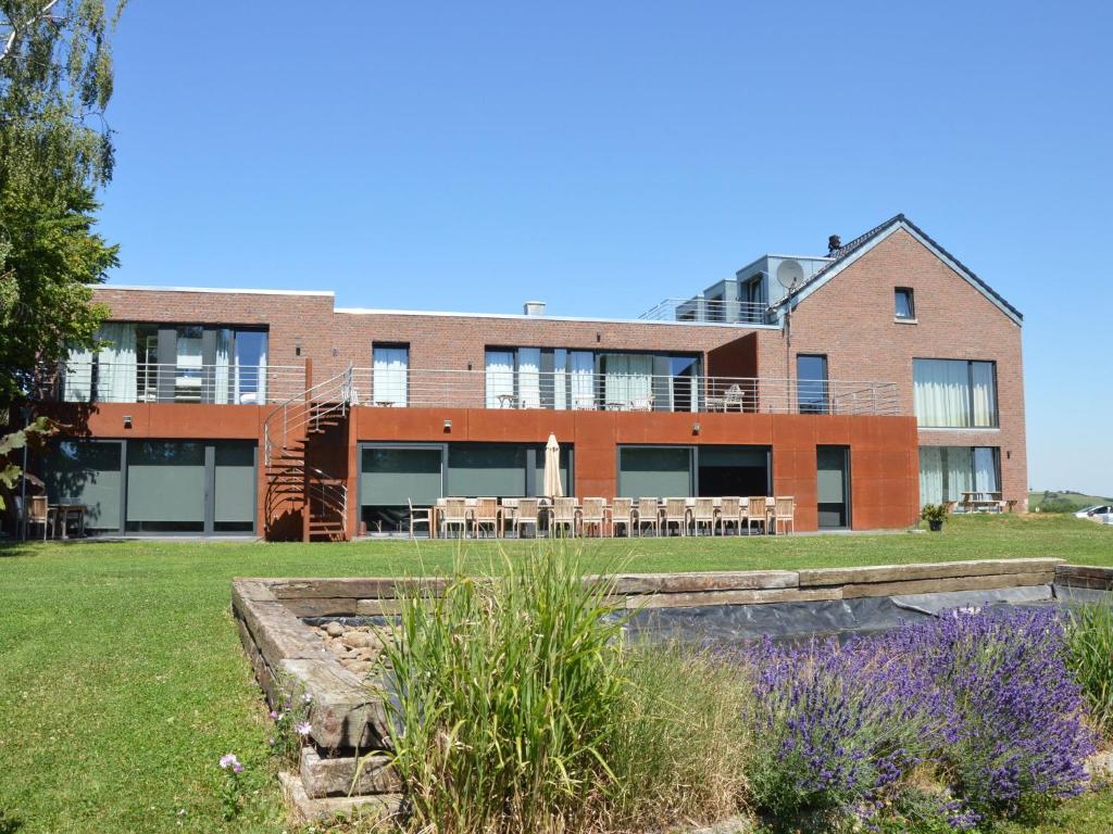 un edificio con un jardín delante de él en Superb Holiday Home with Barbecue, en Plombières