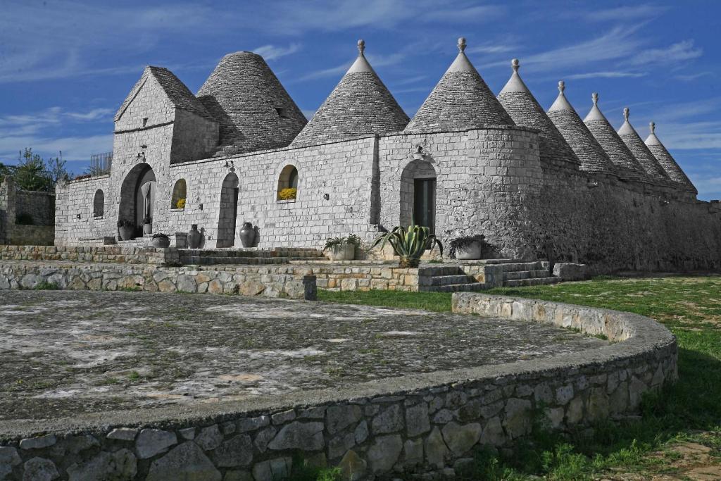 an old stone building with turrets at Masseria Montanaro in Cisternino