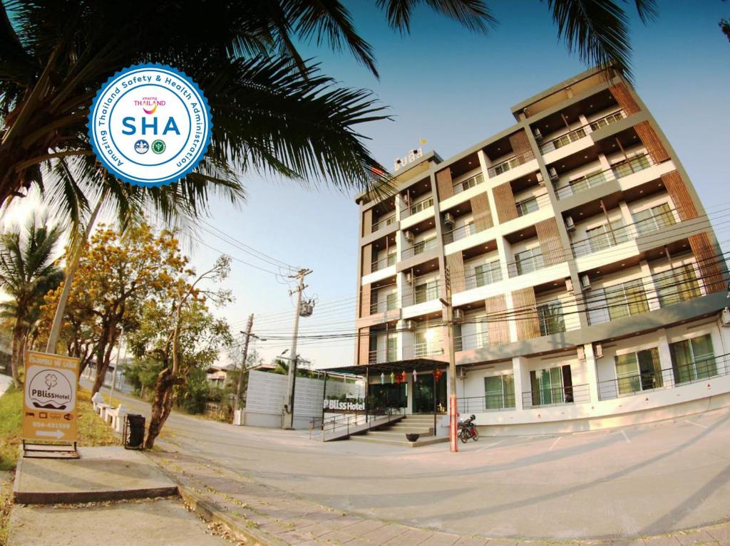 a hotel with a sign in front of a building at P Bliss hotel in Phayao