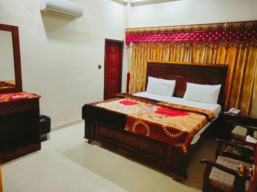 a bedroom with a bed and a red door at New Royal Residency PECHS in Karachi