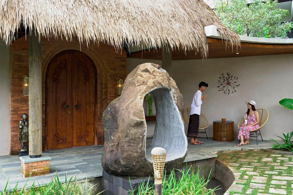 a man and a woman standing outside of a house at Lalasa Villas Canggu in Canggu