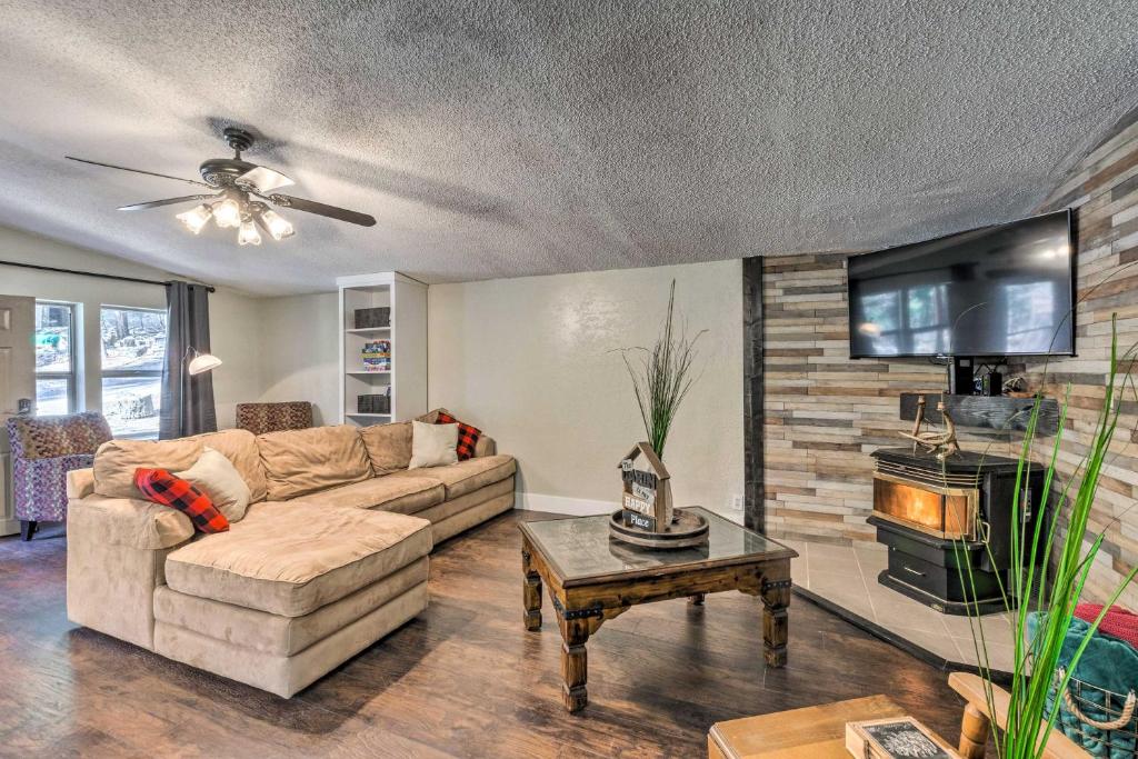 a living room with a couch and a tv at Relaxing Lincoln Forest Retreat with Wraparound Deck in Cloudcroft