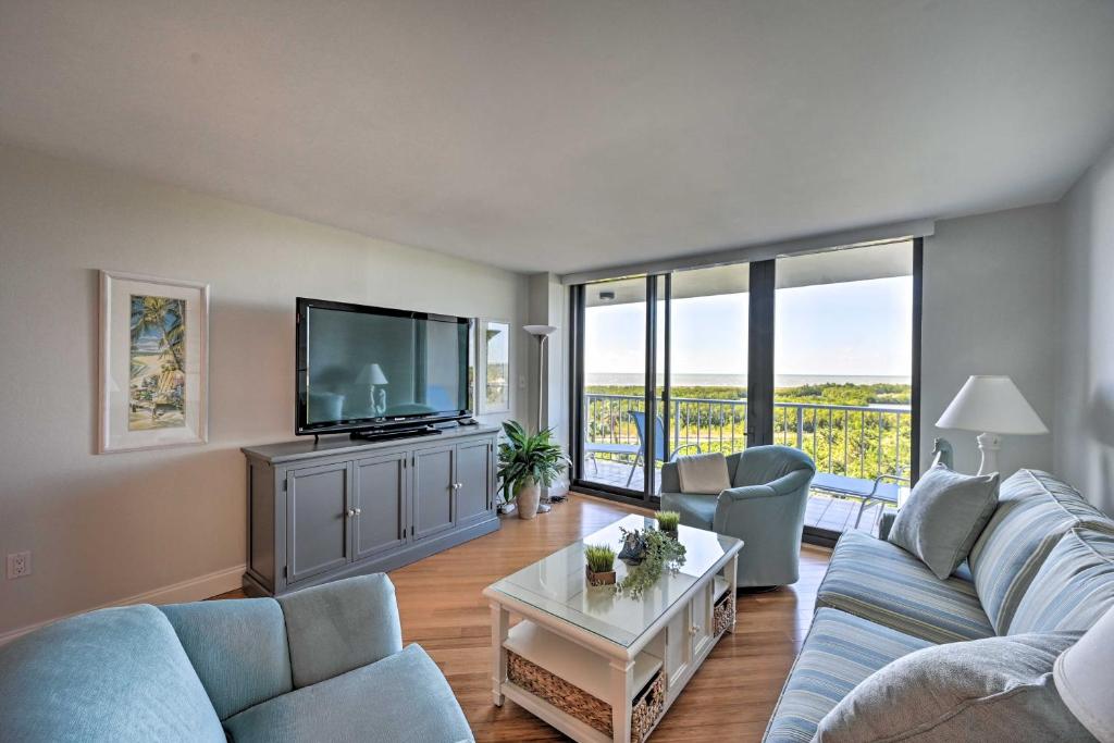 a living room with a couch and a tv at Resort-Style Condo with Pool, Gym, Tennis and More! in Marco Island