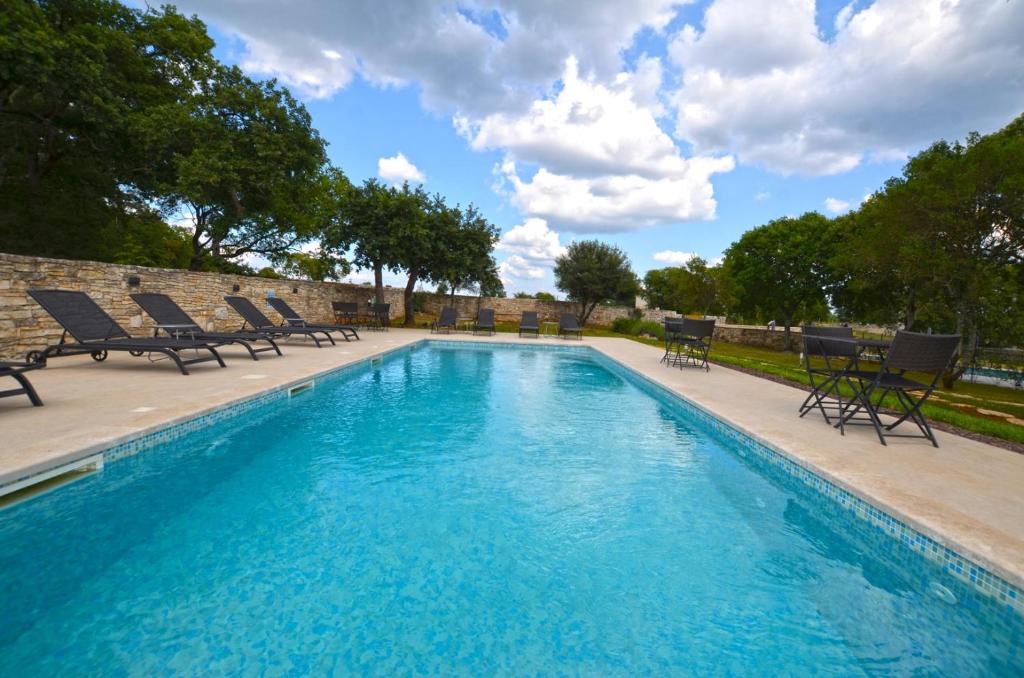 a swimming pool with chaise lounge chairs next to it at App & Rooms Juraga in Bale