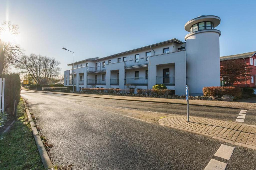 a building with a lighthouse on the side of a road at Haus Leuchtfeuer/Eagle in Warnemünde