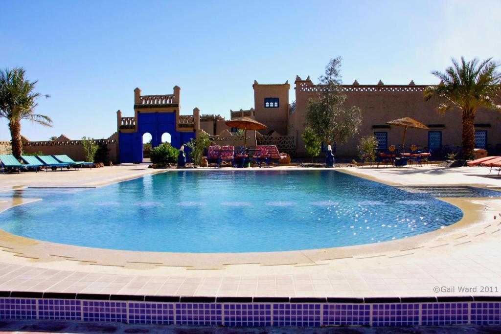 a large swimming pool in front of a building at Ksar Bicha in Merzouga