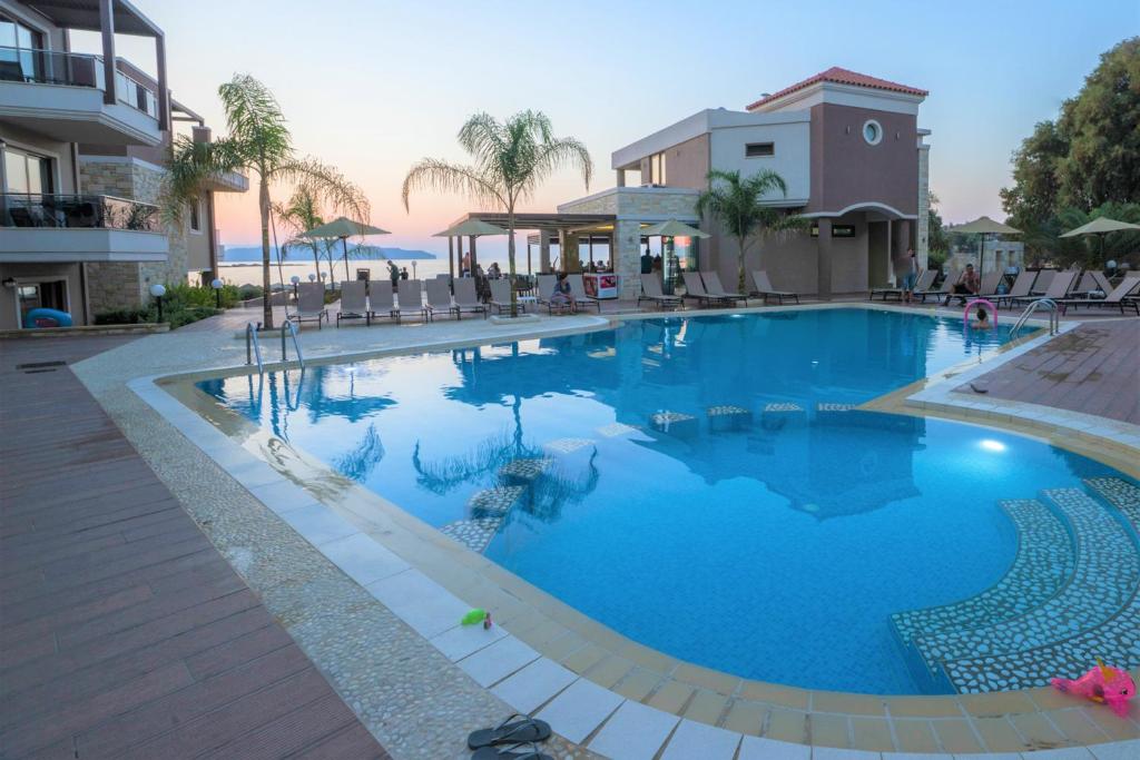 a large swimming pool with blue water in a resort at Golden Bay in Kato Daratso