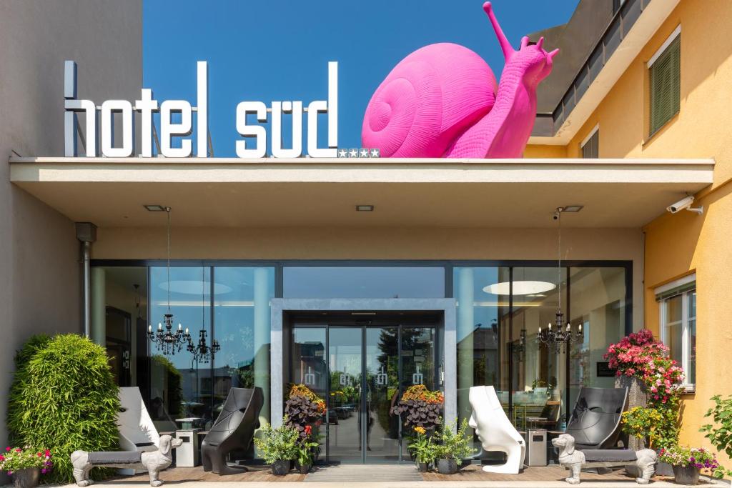 a building with a large inflatable pink snail on it at Hotel Süd Graz in Graz