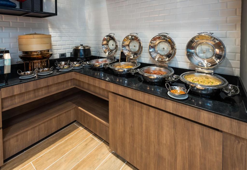 A hot breakfast buffet with covered dishes and several prepared side dishes.