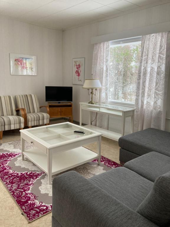 a living room with a couch and a coffee table at Suutalan Mansikkatalo in Ylipää