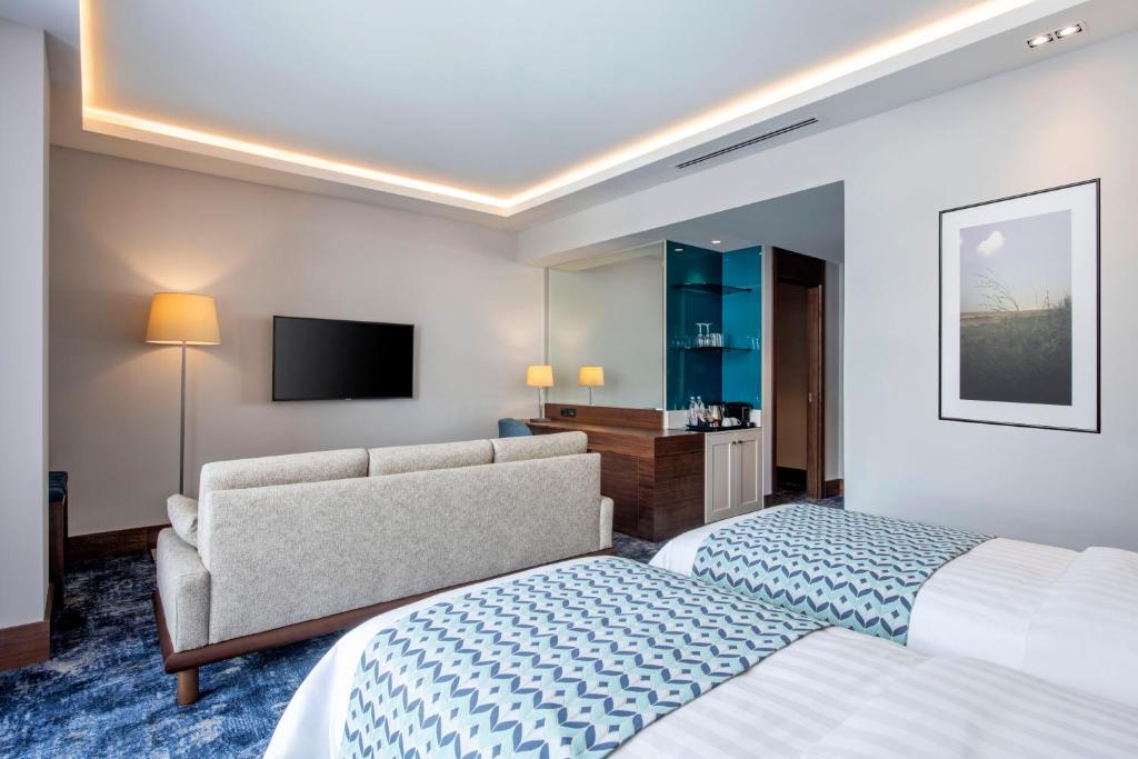 Postel nebo postele na pokoji v ubytování Ambassadori Goderdzi Hotel