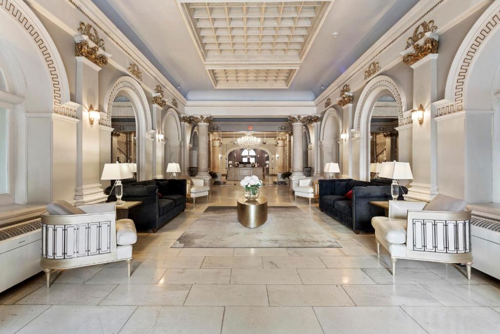 a lobby of a building with couches and tables at The Historic Divine Lorraine Apartments in Philadelphia