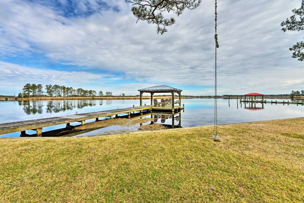 a dock with a gazebo on a lake at Waterside Belhaven House and Cottage with Porch and Dock in Belhaven