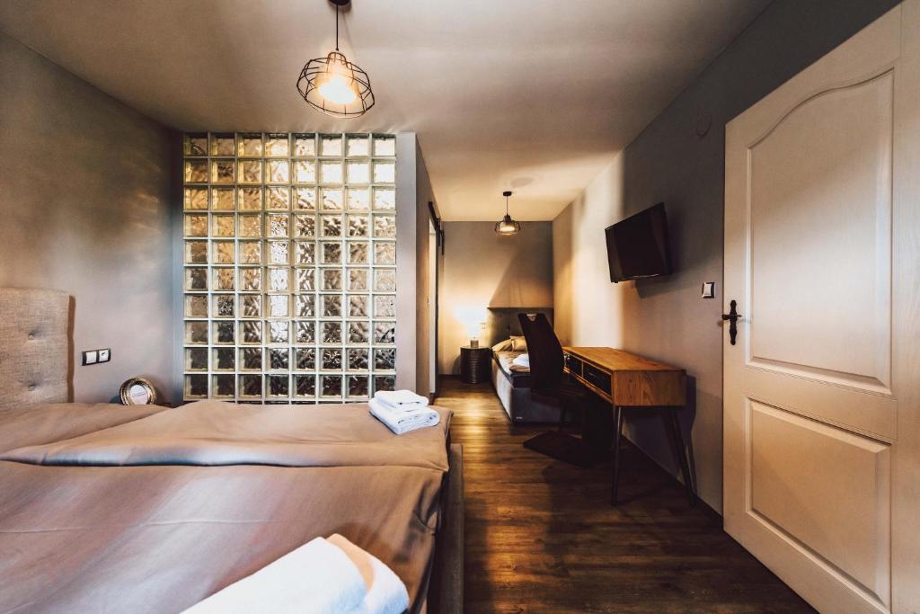 Postel nebo postele na pokoji v ubytování Resort Mlýn Černovice