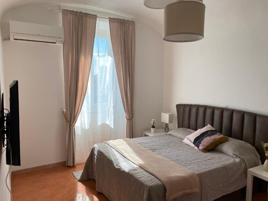 a bedroom with a large bed and a window at Campani apartment in Rome