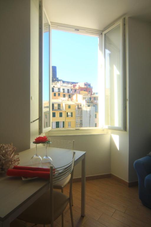a dining room with a table and a large window at Vernazza Vacation 2 in Vernazza