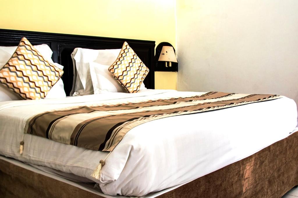 Postel nebo postele na pokoji v ubytování PrideInn Flamingo Beach Resort & Spa Mombasa