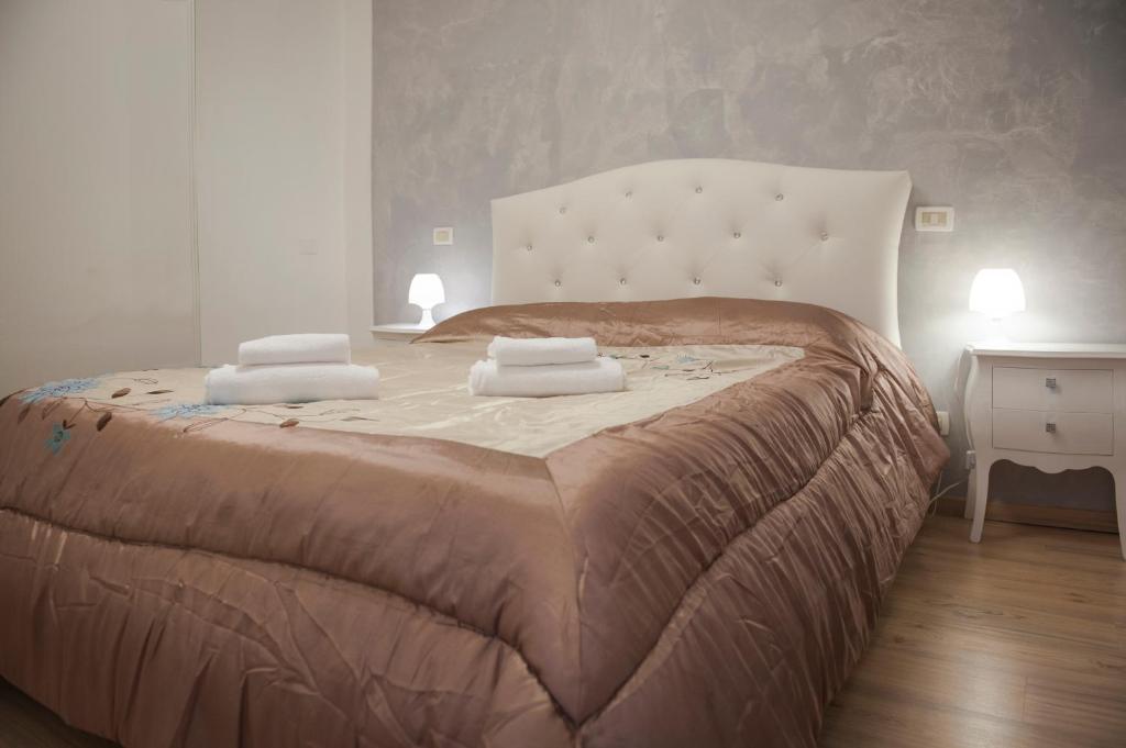 a bedroom with a large bed with two towels on it at Porta Orientalis Venice in Venice