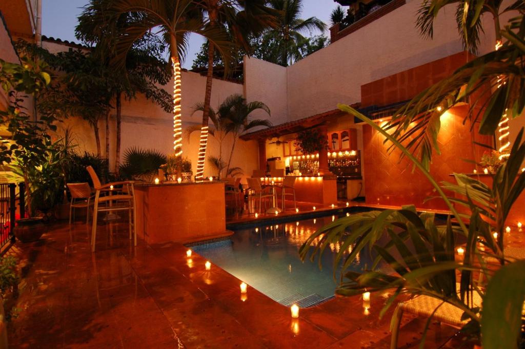 a swimming pool with lights in a resort at Hotel Mercurio - Gay Friendly in Puerto Vallarta