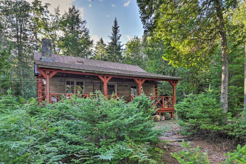 a log cabin in the woods with trees at Lakeside Livin Cozy Cabin Steps to Sebec Lake! 