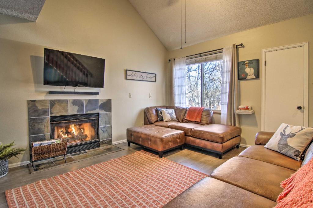 a living room with a couch and a fireplace at Manitou Springs Condo with Hammock and Mtn Views! in Manitou Springs
