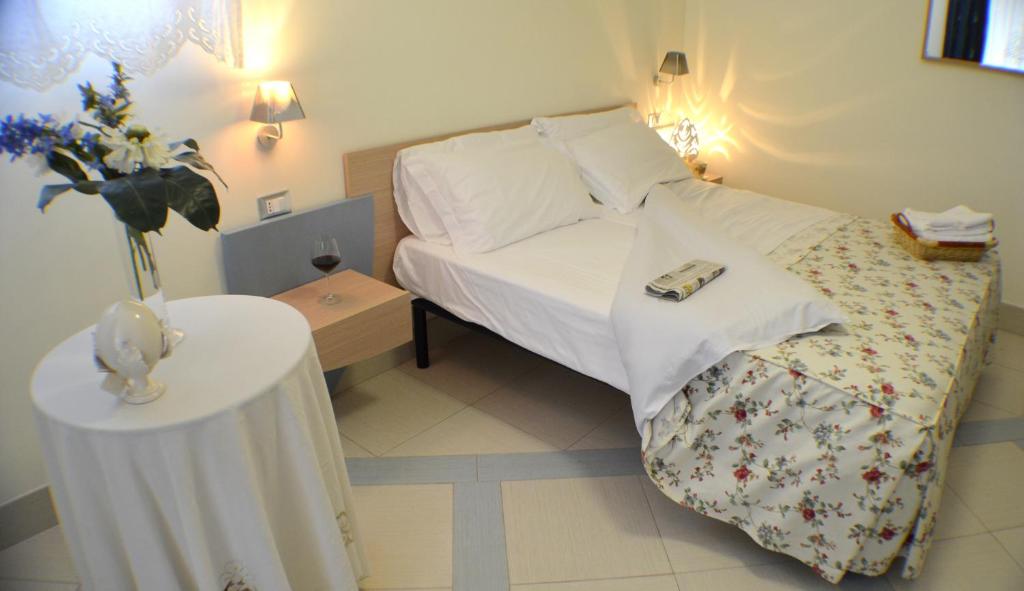 a small bedroom with a bed and a table at Masseria Asciano in Ostuni