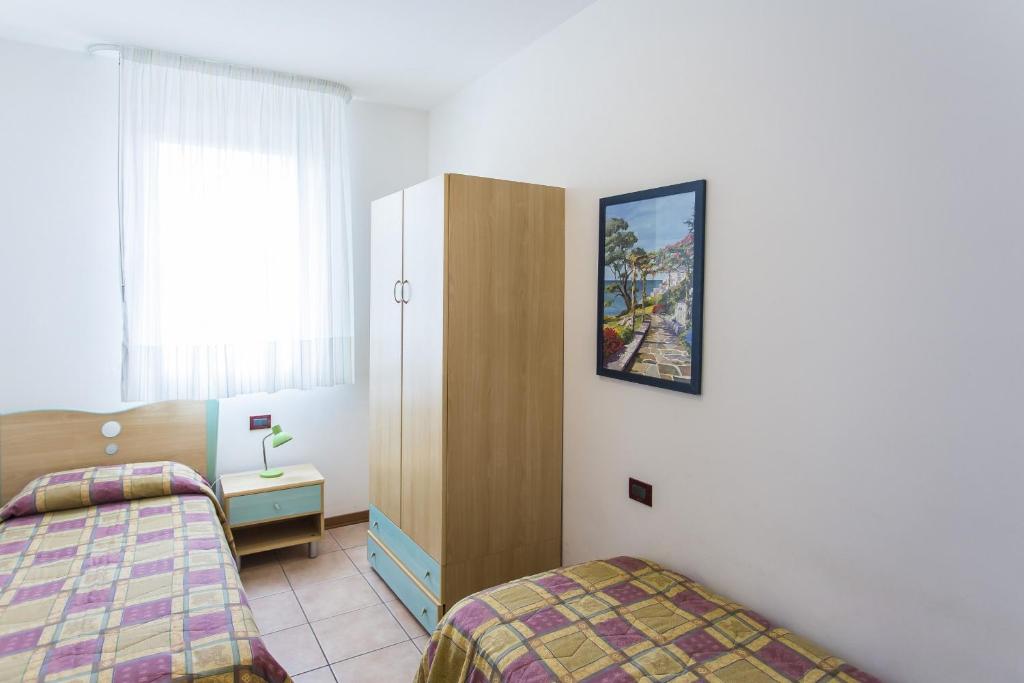A bed or beds in a room at Villaggio Calycanthus