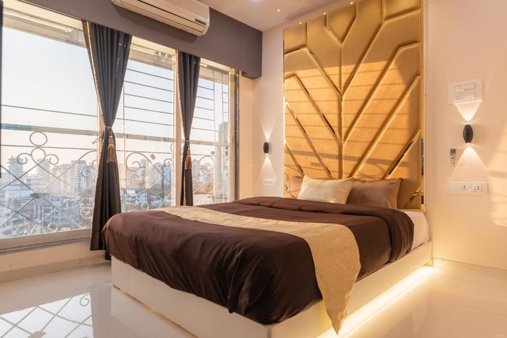 a bedroom with a large bed and a window at OSI Apartments Bandra West in Mumbai