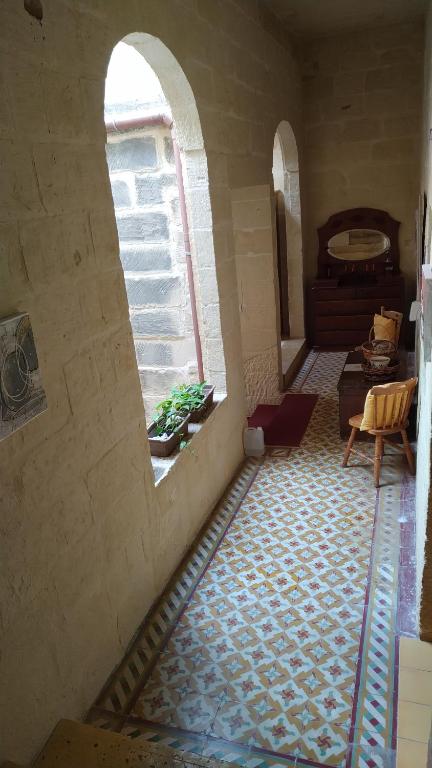 a room with an arched window and a floor at Ta’ Lorenzo in San Lawrenz