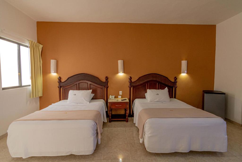 Postel nebo postele na pokoji v ubytování Hotel María Jose