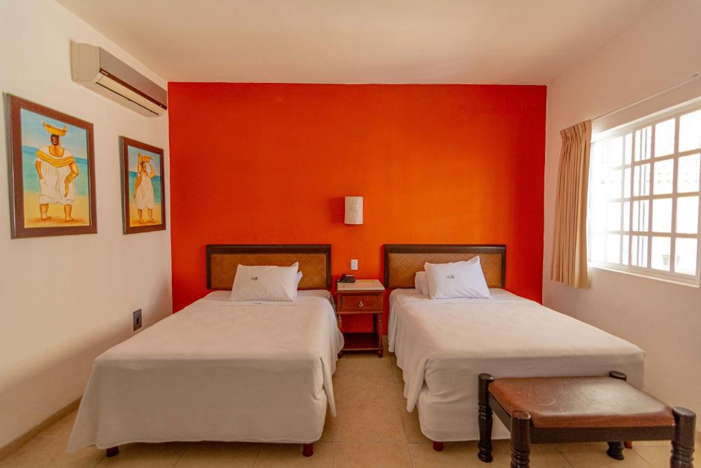 Postel nebo postele na pokoji v ubytování Hotel María Jose