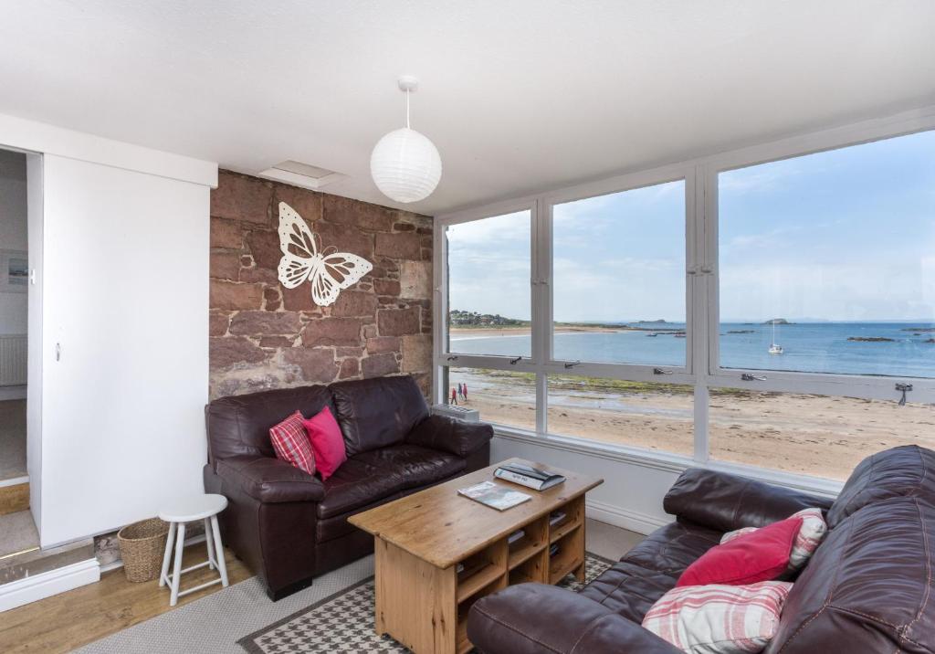 a living room with a couch and a table at The Gulls in North Berwick