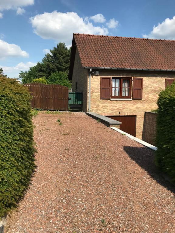 a house with a gravel driveway in front of it at Le Valdine in Jemeppe