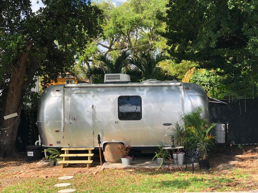 a silver trailer parked next to a fence at Airstream in the Center of it All - RG in Miami