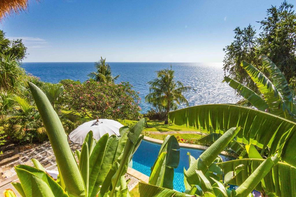 a swimming pool with a view of the ocean at Aquamarine Seaview Villa in Amed