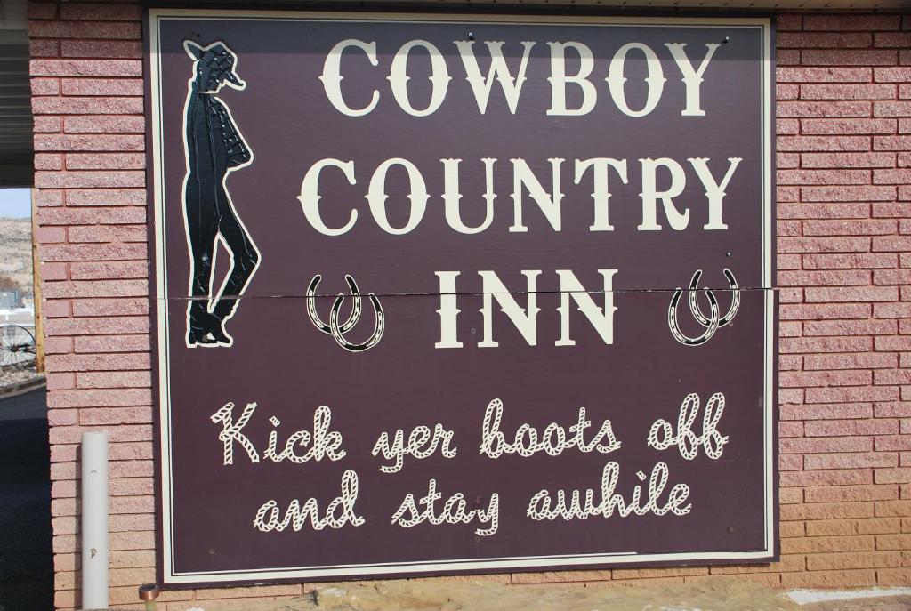 a sign on the side of a building at Cowboy Country Inn in Escalante