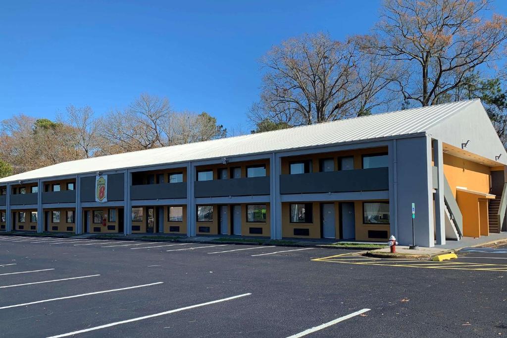 a large blue building with a parking lot at Super 8 by Wyndham Newport News in Newport News