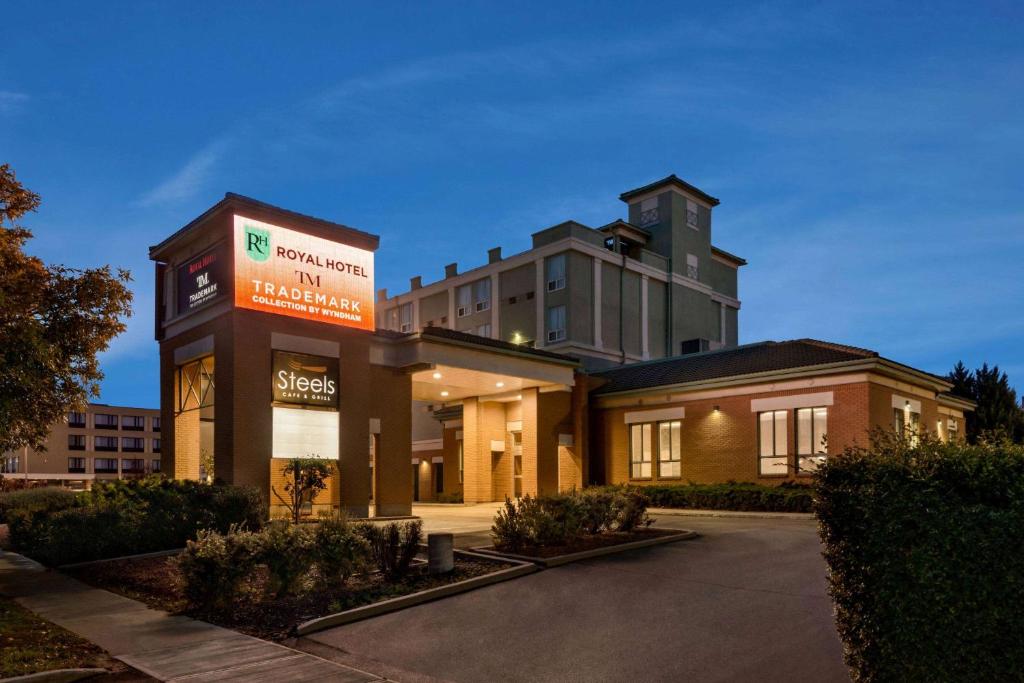 a building with a sign in front of it at Royal Hotel Regina, Trademark Collection by Wyndham in Regina