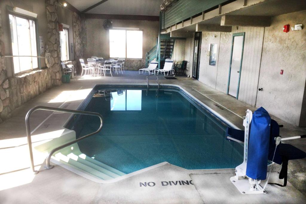 a swimming pool with a no diving sign in a building at Super 8 by Wyndham Petoskey in Petoskey