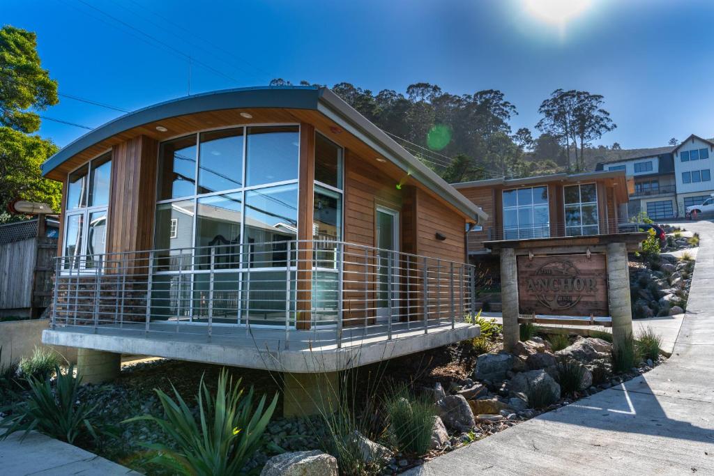 a house with a large window and a balcony at Anchor Inn Pacifica in Pacifica