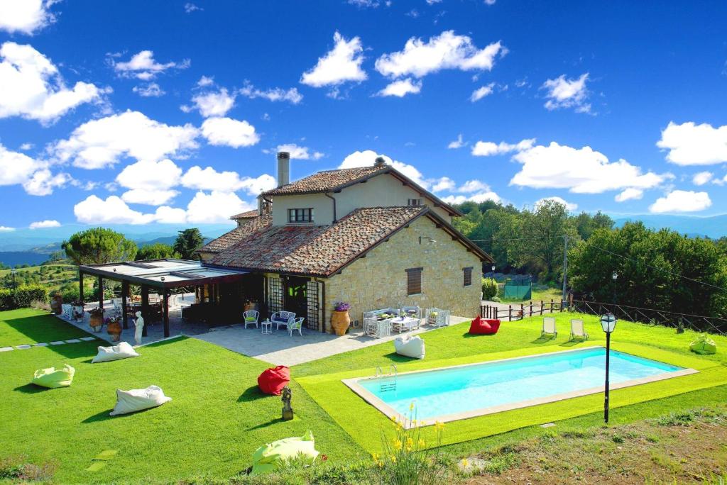 a house with a swimming pool in the yard at Villa Umbra in Città di Castello