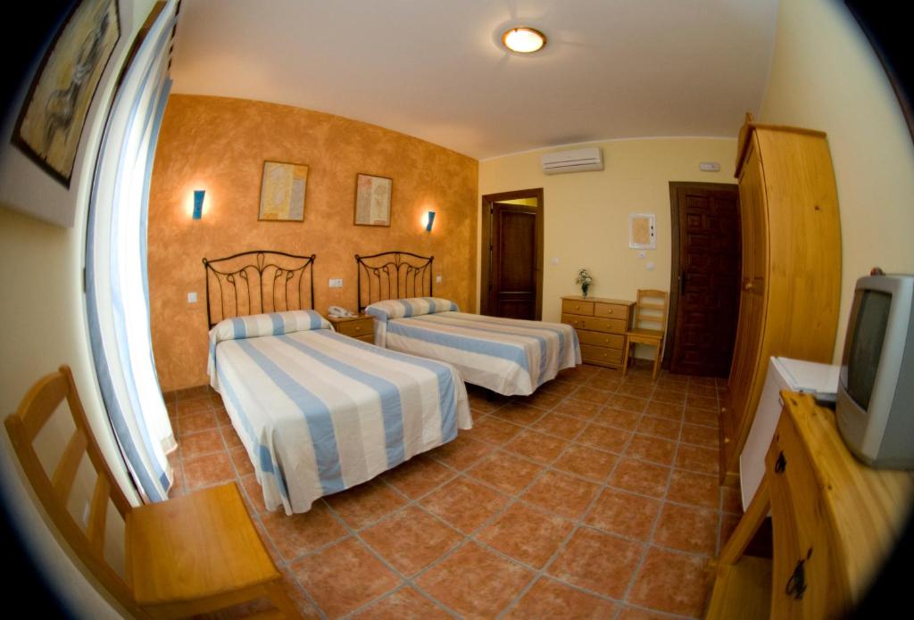 Posteľ alebo postele v izbe v ubytovaní Hotel Rural El Arriero
