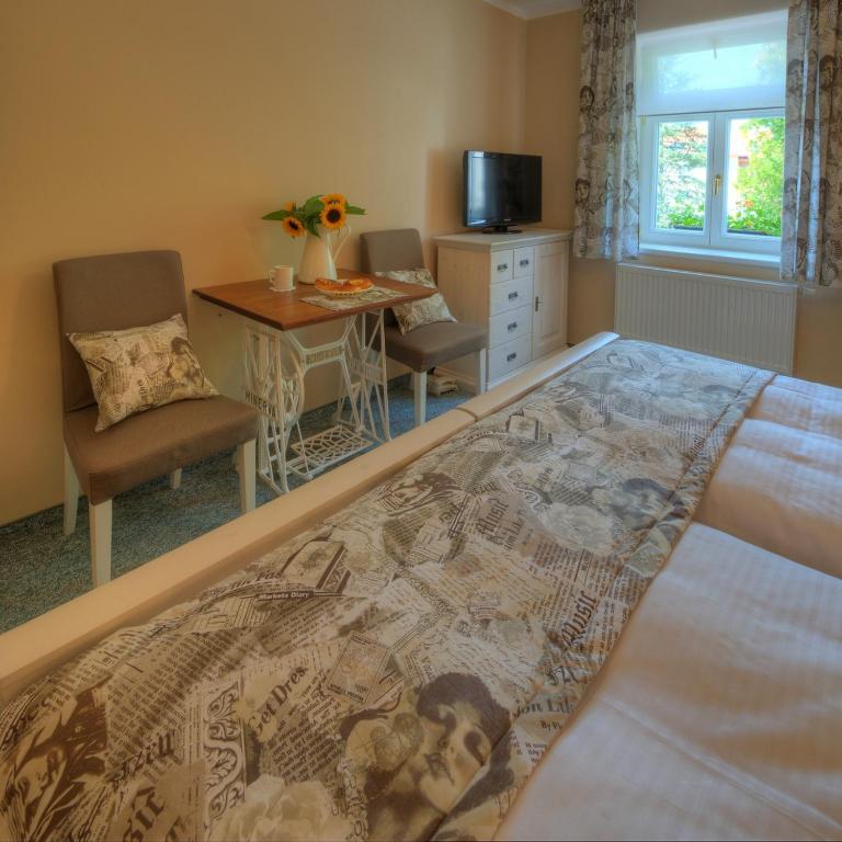 Łóżko lub łóżka w pokoju w obiekcie Hotel Panský dům