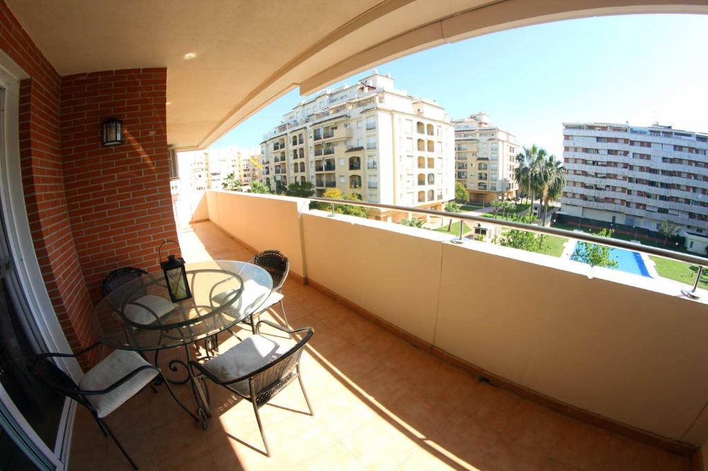 a balcony with a table and chairs on a building at Parque Central 3 in Estepona