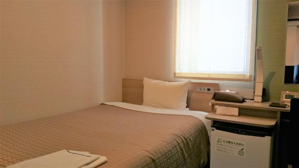 Postel nebo postele na pokoji v ubytování Meet Inn Narita
